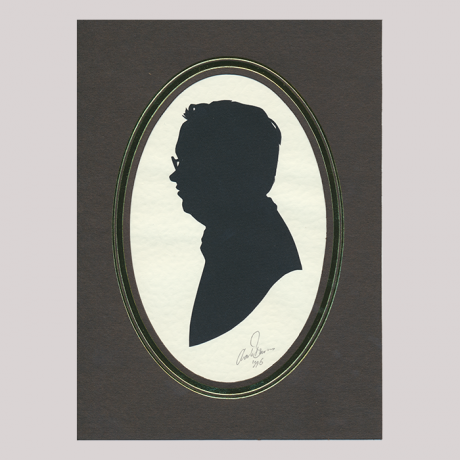 
        Front of silhouette, with man in frame looking left, wearing glasses.